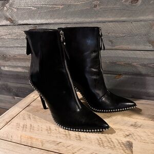 Black man made material with silver studs around boots